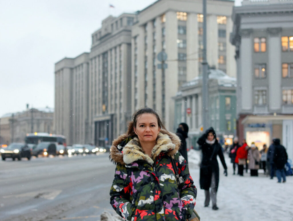 Maria Andreeva, whose husband was mobilised in October, 2022, to join the Russian armed forces involved in a military campaign in Ukraine, poses for a picture in front of the headquarters of State Duma, the lower house of parliament, in central Moscow, Russia, on 30th November, 2023.