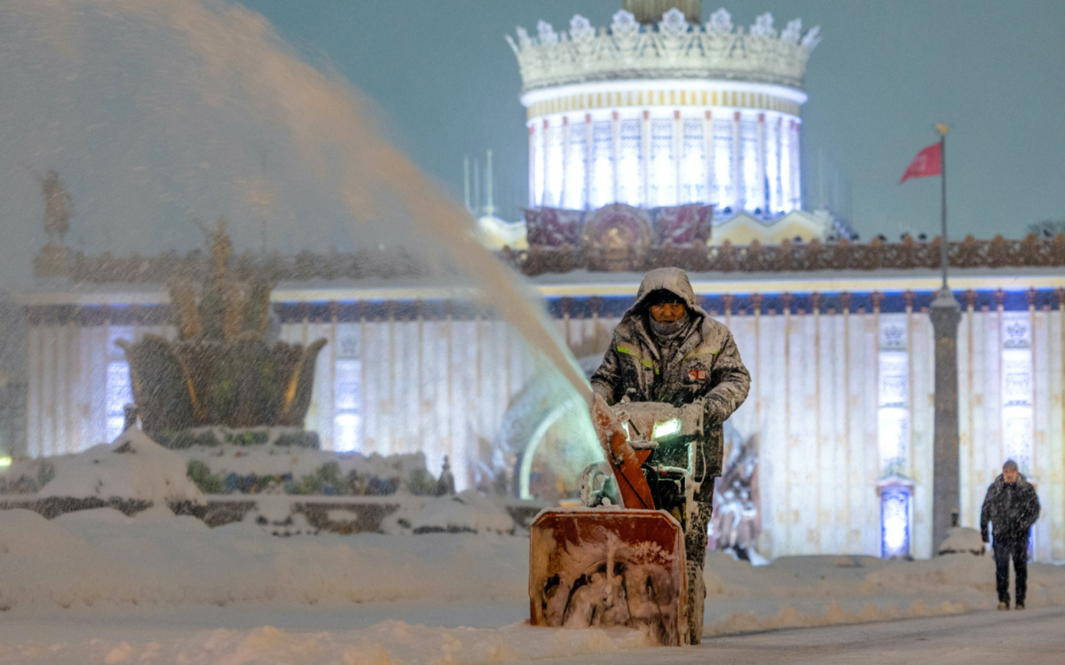 A communal worker cleans snow at the Exhibition of Achievements of National Economy during a heavy snowfall in Moscow, Russia, on 3rd December, 2023. 