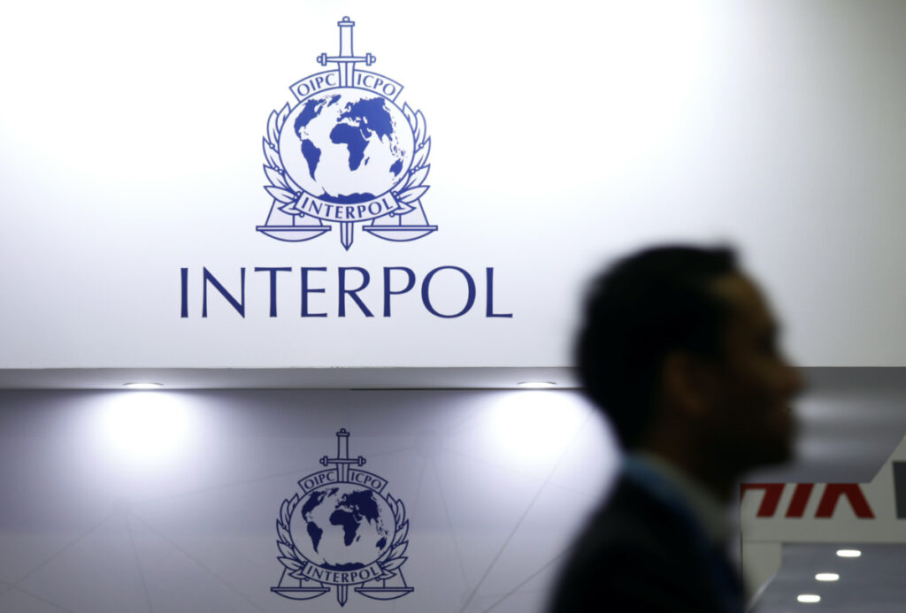 A man passes Interpol signages at Interpol World in Singapore on 2nd July, 2019.