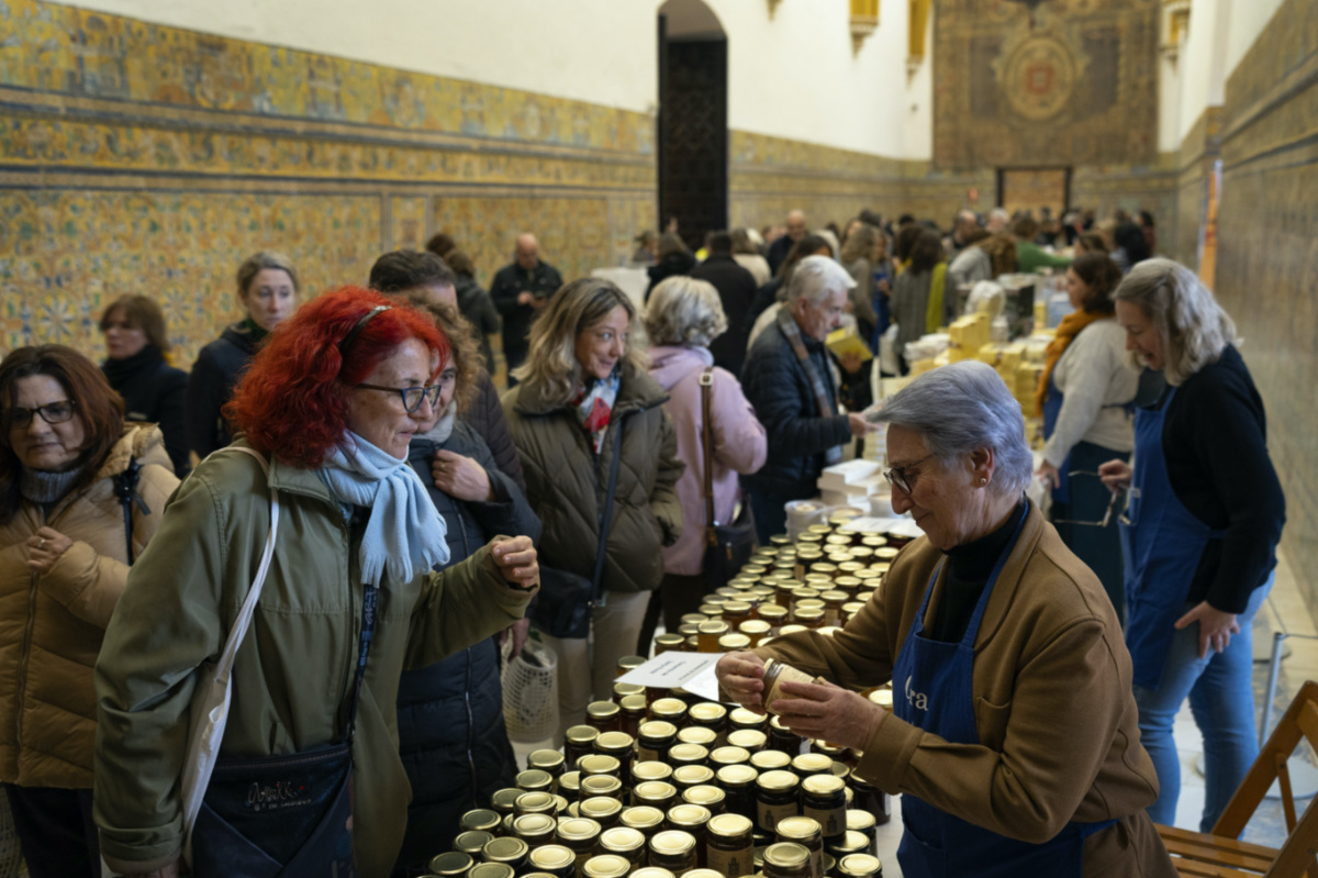 Customers buy marmalades and cakes made by cloistered nuns, at a market at the Reales Alcazares in Seville, Spain, on Tuesday, 5th December, 2023