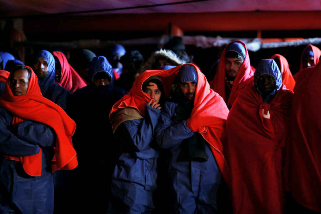 Migrants, intercepted off the coast in the Mediterranean Sea, wait to disembark from a rescue boat at the port of Malaga, southern Spain, on 3rd January, 2019