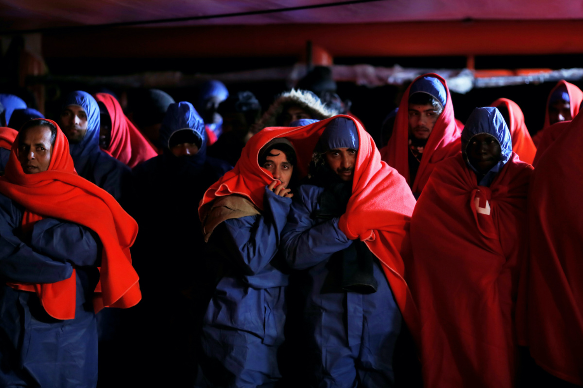 Migrants, intercepted off the coast in the Mediterranean Sea, wait to disembark from a rescue boat at the port of Malaga, southern Spain, on 3rd January, 2019