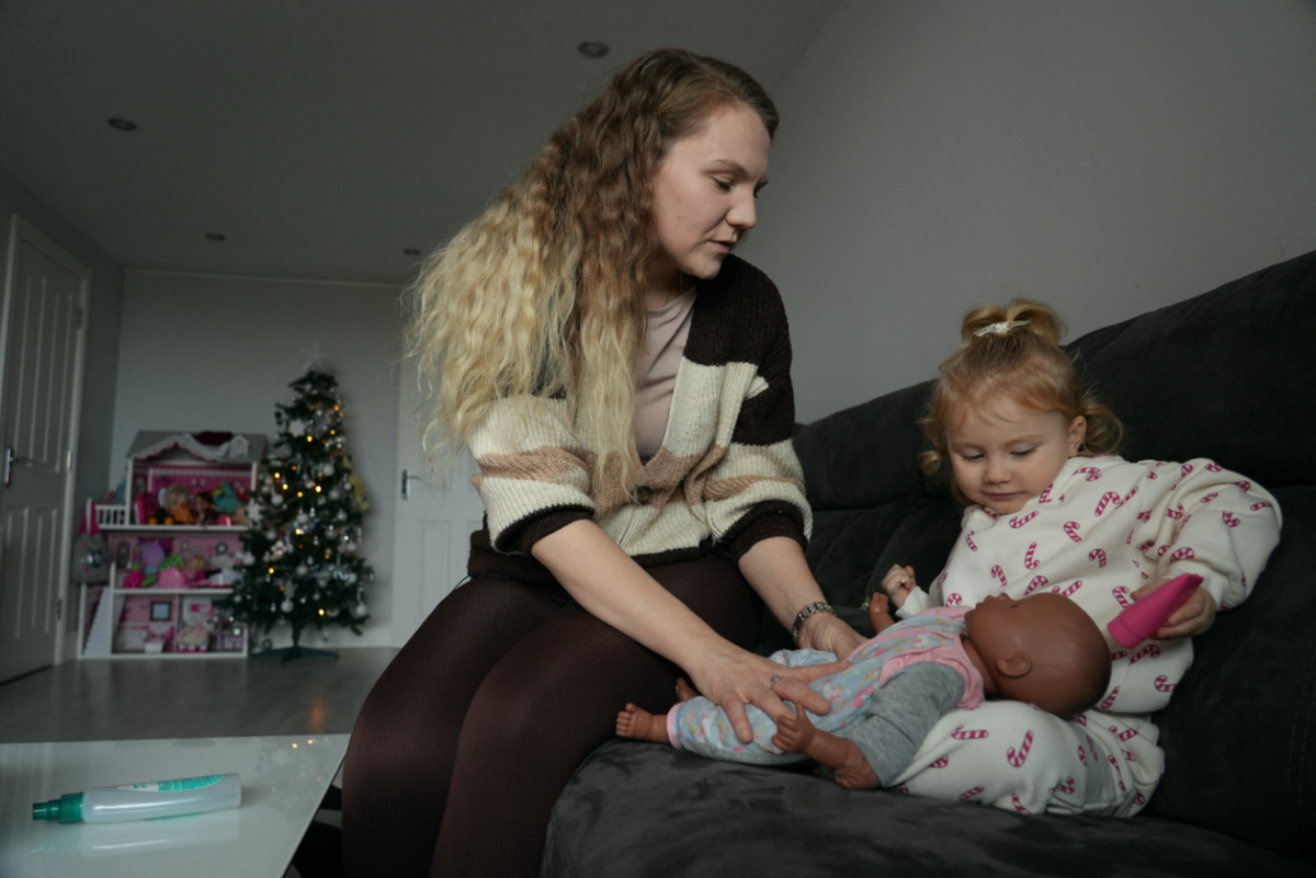 Paige Ballmi poses with her daughter Fifi at their home during an interview with Reuters, in London, Britain, on 15th December, 2023