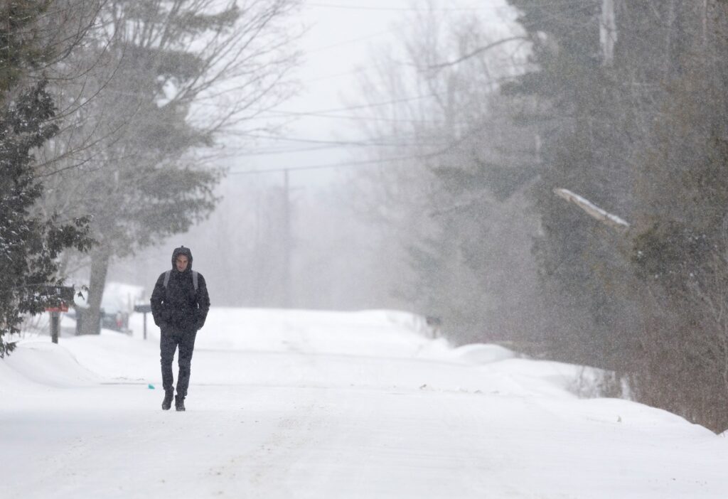 An asylum seeker walks down Roxham Road to cross into Canada from the US in Champlain, New York, US, on 28th February, 2023