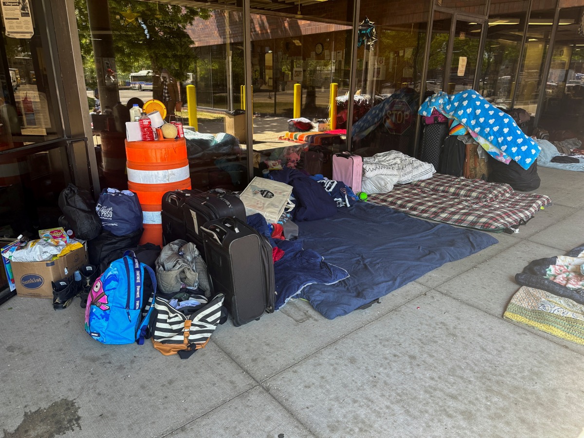 Makeshift beds and other belongings of migrants are laid on the ground outside a police station in Chicago, Illinois, US, on 26th May, 2023
