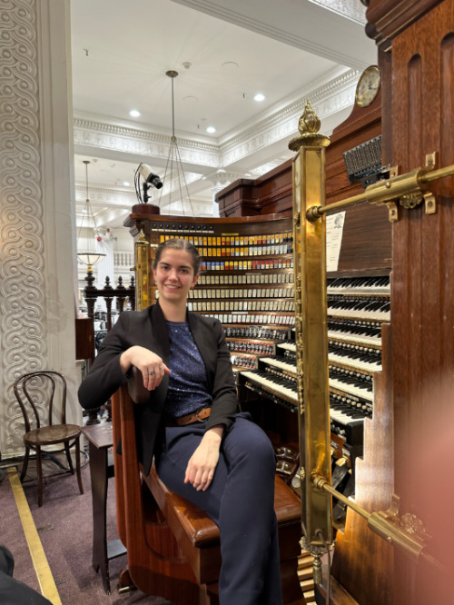 Emily Amos poses with the Wanamaker Organ in Philadelphia in 2023. 