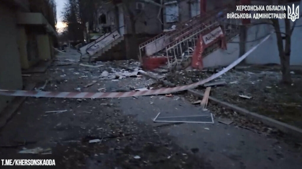 Debris is scattered along a street after shelling in a residential block in Kherson, Ukraine, in this screengrab taken from a video released on 3rd December, 2023