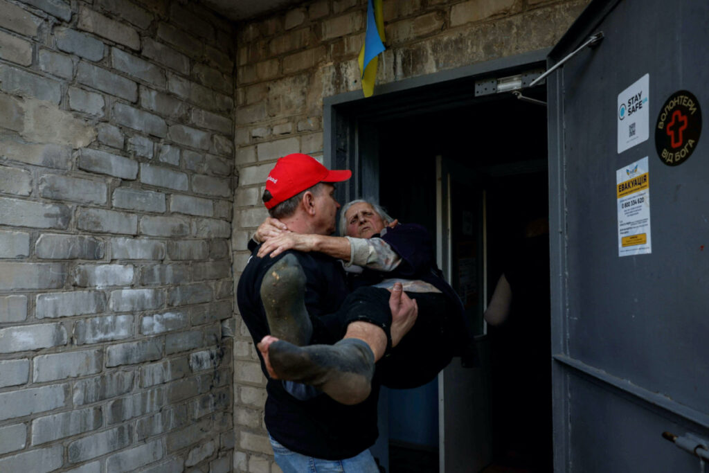 Yevhen Tkachov, 54 year-old, volunteer and local citizen, carries Nelia, 85 year-old, to a shelter for internally displaced people in Kostiantynivka, amid Russia's attack on Ukraine, in Donetsk region, Ukraine on 8th November, 2023. REUTERS/Alina Smutko