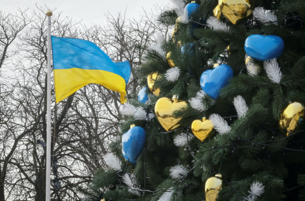 A view shows a Christmas tree near a Ukrainian national flag as Ukrainians around the country are gearing up to celebrate their first Christmas according to a Western calendar, amid Russia's attack on Ukraine, in Kyiv, Ukraine, on 20th December, 2023
