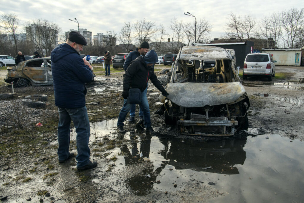 People inspect cars destroyed during a Russian missile and drone strike, amid Russia's attack on Ukraine, in Kyiv, Ukraine, on 29th December, 2023