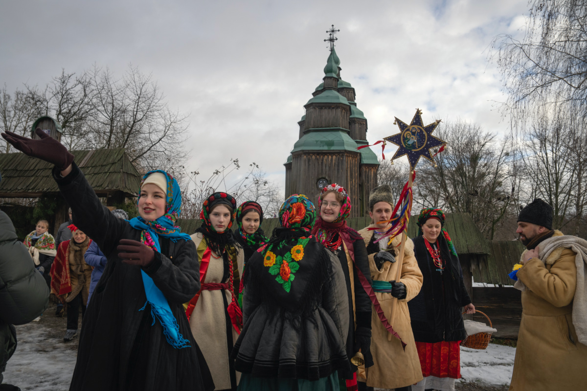 People dressed in national suits celebrate Christmas in the village of Pirogovo outside capital Kyiv, Ukraine, on Monday, 25th December, 2023.