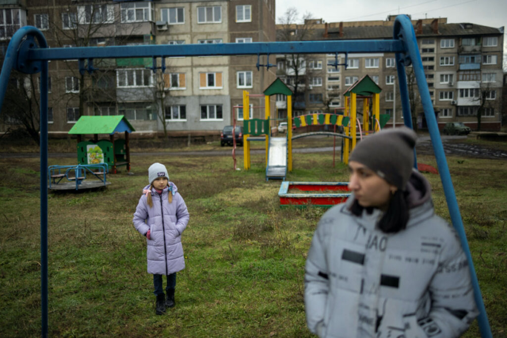 Iryna and her daughter, third-grader Arina, stand in a playground after an online reading class in Sloviansk, amid Russia's attack on Ukraine, on 20th December, 2023.