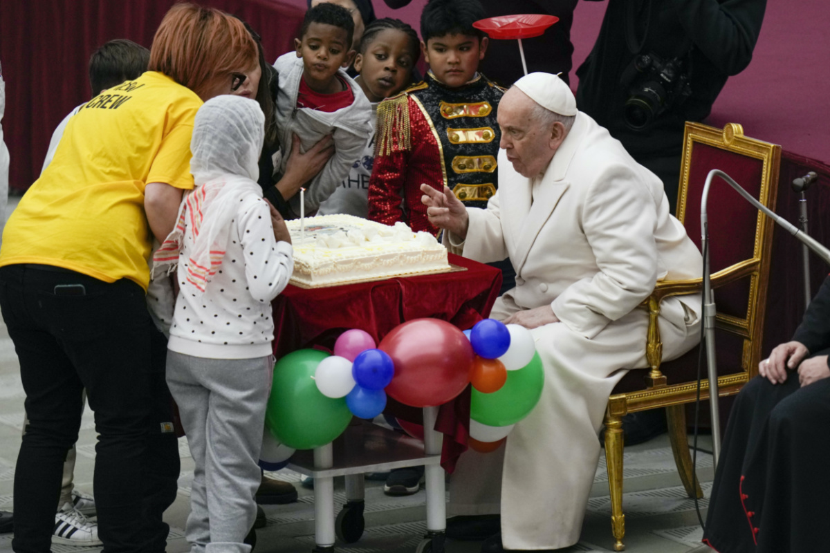 Pope Francis blows a candle on a cake as he celebrates his birthday with children assisted by the Santa Marta dispensary during an audience in the Paul VI Hall, at the Vatican, on Sunday, 17th December 2023. 