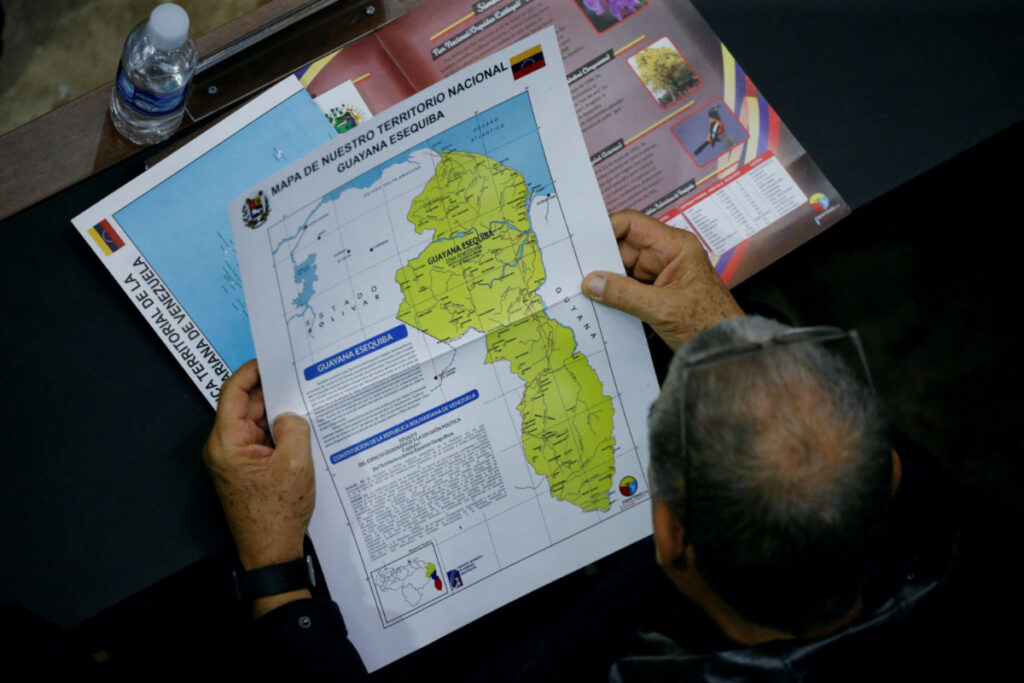 A member of the National Assembly of the Assembly holds a map showing the disputed Esequibo region as part of Venezuela, as tensions between the Venezuela and Guyana have ratcheted up in recent weeks over a long-running territorial dispute, in Caracas, Venezuela, on 6th December, 2023.