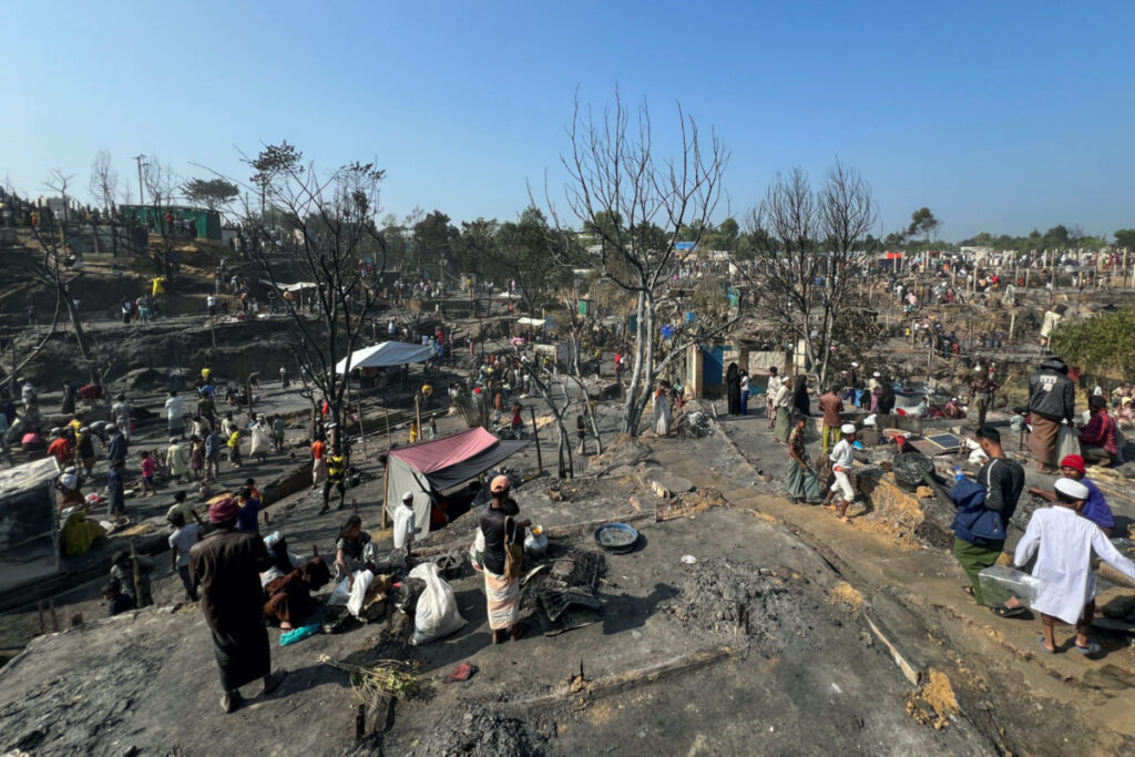 Rohingya refugees work on rebuilding their makeshift shelters after a fire broke out in a camp in Cox's Bazar, Bangladesh, on 7th January, 2024.