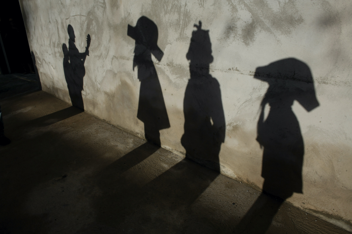Shadows of revelers of the Estrela Dalva Folia de Reis Group are cast on a wall during Epiphany, or Three Kings Day, celebrations in the city of Planaltina, Brasilia, Brazil, Monday, on 6th January, 2020