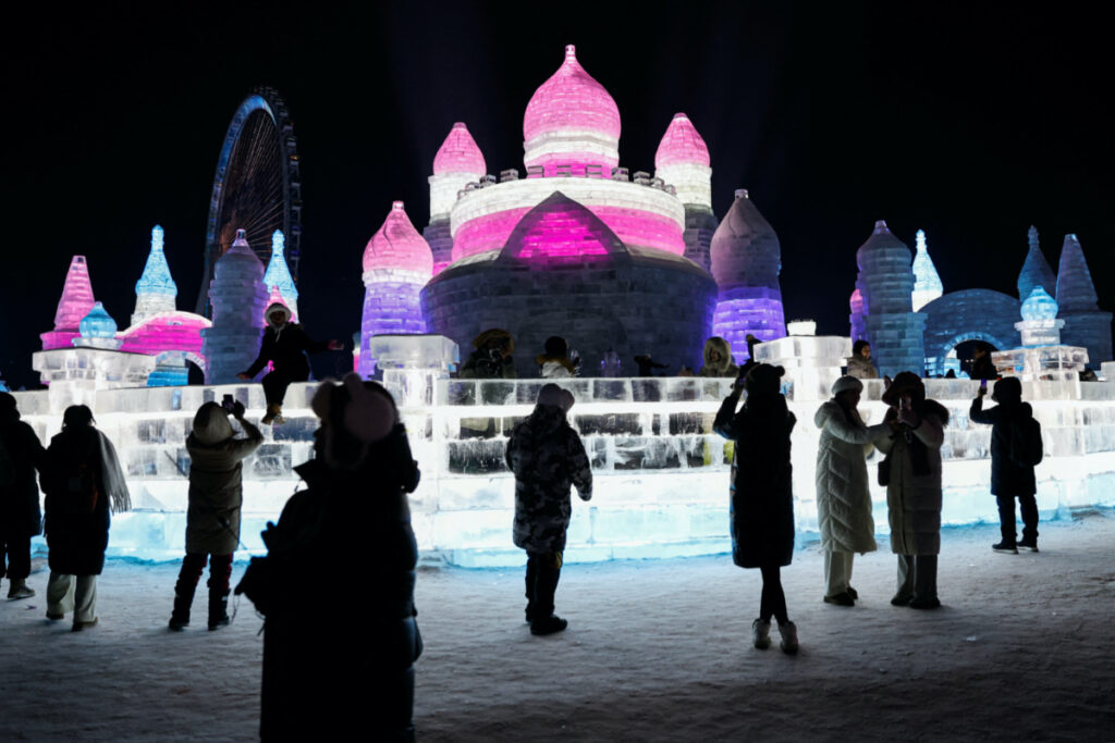 People visit an ice sculpture at the Harbin International Ice and Snow Festival, in Harbin, Heilongjiang province, China on 4th January, 2024