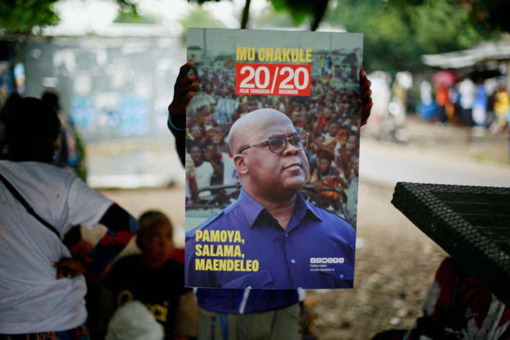 A supporter of holds a portrait of president Felix Tshisekedi of Union for Democracy and Social Progress as they prepare to celebrate ahead of the announcement of provisional results of the December presidential election, at their party's headquarters in Kinshasa, Democratic Republic of Congo on 31st December, 2023.