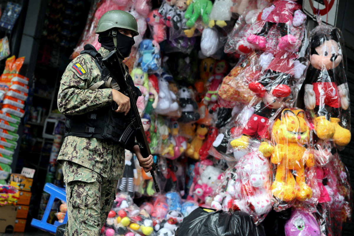 An armed soldier patrols a commercial area, in the aftermath of a wave a violence that saw the storming of a TV station on-air and explosions around the nation, in Quito, Ecuador, on 11th January, 2024.