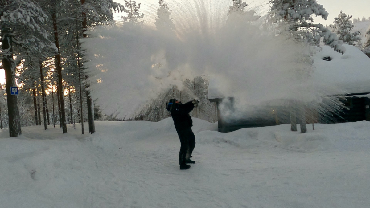A person throws boiling water into the air following cold weather, in Pyhatunturi, Finland, on 1st January, 2024