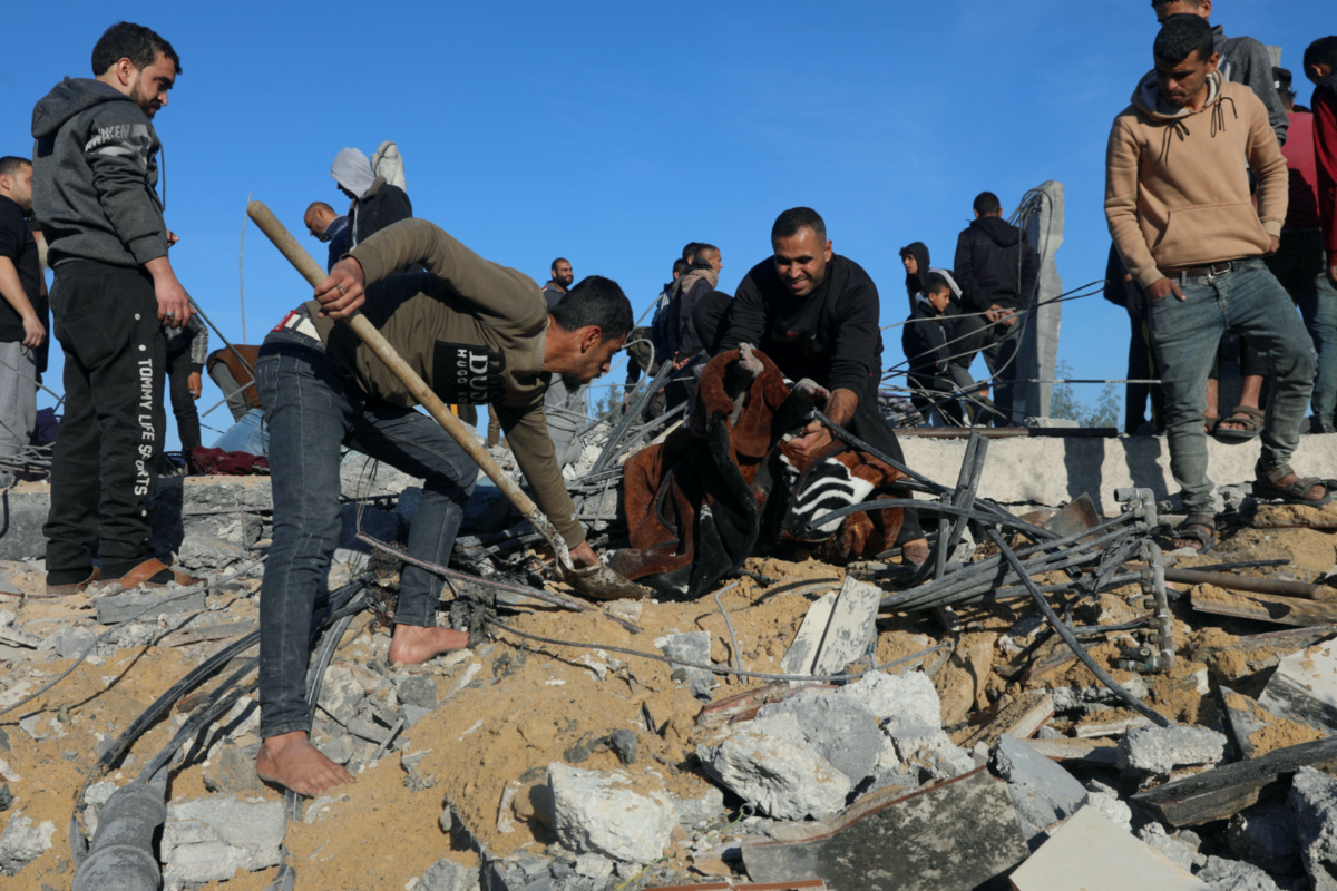 Palestinians search for casualties at the site of an Israeli strike, in Rafah in the southern Gaza Strip, on 7th January, 2024