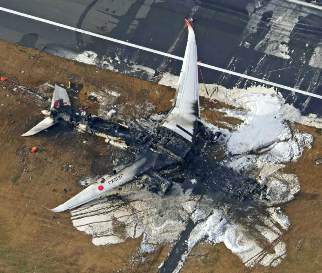 An aerial view shows burnt Japan Airlines' Airbus A350 plane after a collision with a Japan Coast Guard aircraft at Haneda International Airport in Tokyo, Japan, on 3rd January, 2024, in this photo taken by Kyodo.