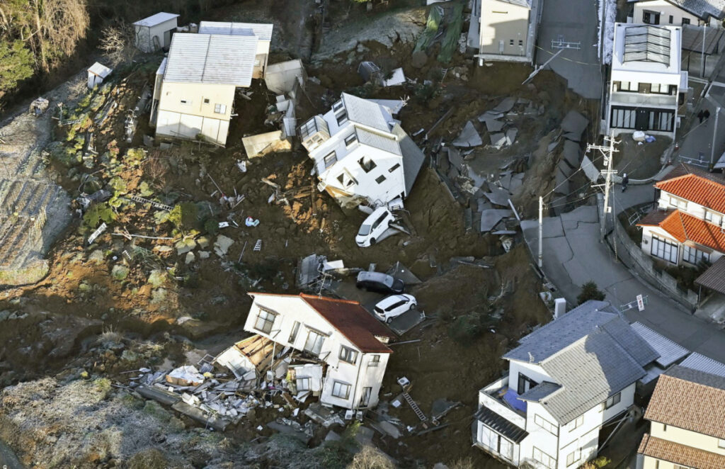 An aerial view shows collapsed houses, cars and roads caused by an earthquake in Kanazawa, Ishikawa prefecture, Japan, on 2nd January, 2024