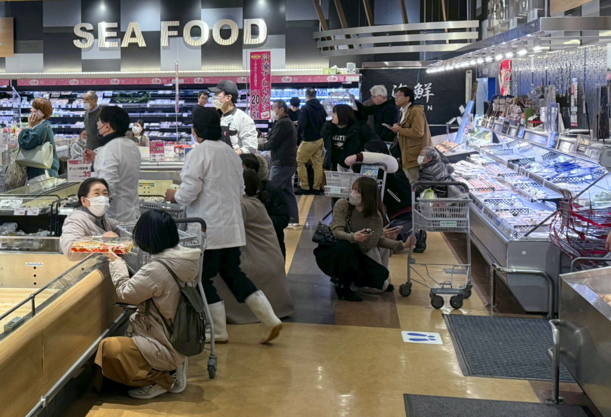Shoppers crouch down as an earthquake hit the region at a supermarket in Toyama, Japan, on 1st January, 2024, in this photo released by Kyodo.