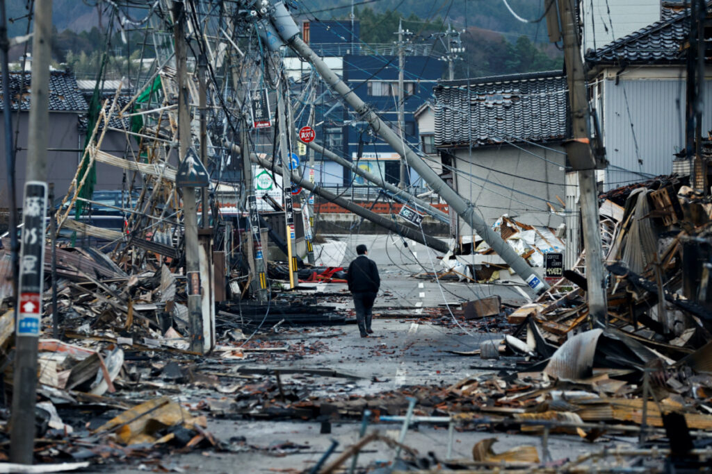 A man makes his way along Asaichi-dori street, which burned down due to a fire following an earthquake, in Wajima, Japan, on 4th January, 2024