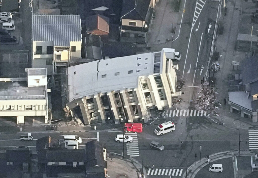 An aerial view shows a collapsed building caused by an earthquake in Wajima, Ishikawa prefecture, Japan, on 2nd January, 2024, in this photo released by Kyodo.