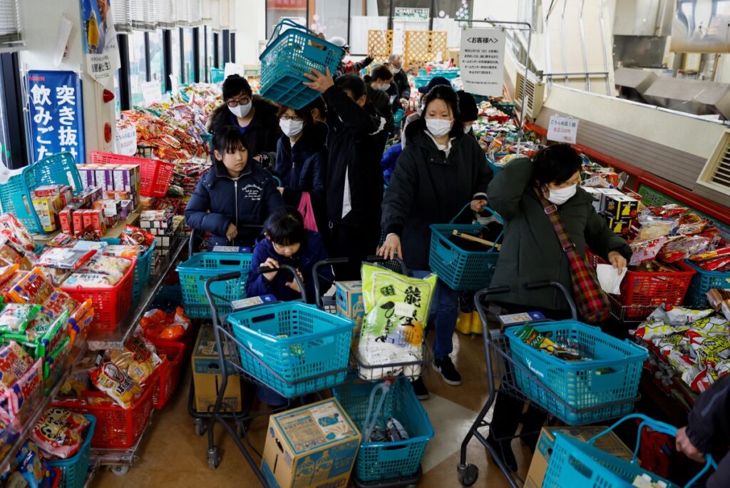 Residents stand in a line to buy goods at a reopened supermarket which was damaged by the earthquake, in Wajima, Ishikawa Prefecture, Japan, on 6th January, 2024