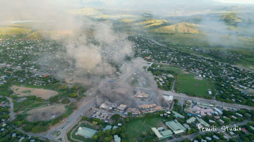 An aerial view of smoke billowing from burning buildings, amid looting and arson during protests over a pay cut for police that officials blamed on an administrative glitch, in Port Moresby, Papua New Guinea on 10th January, 2024 in this screen grab obtained from social media video
