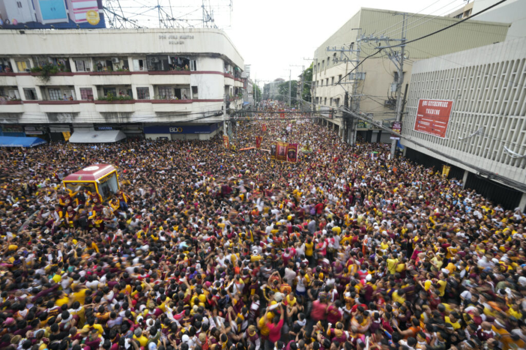 A glass-covered cart carrying the Black Nazarene makes its way through the crowd during its annual procession which was resumed after a three-year suspension due to the coronavirus pandemic on Tuesday, 9th January, 2024 in Manila, Philippines