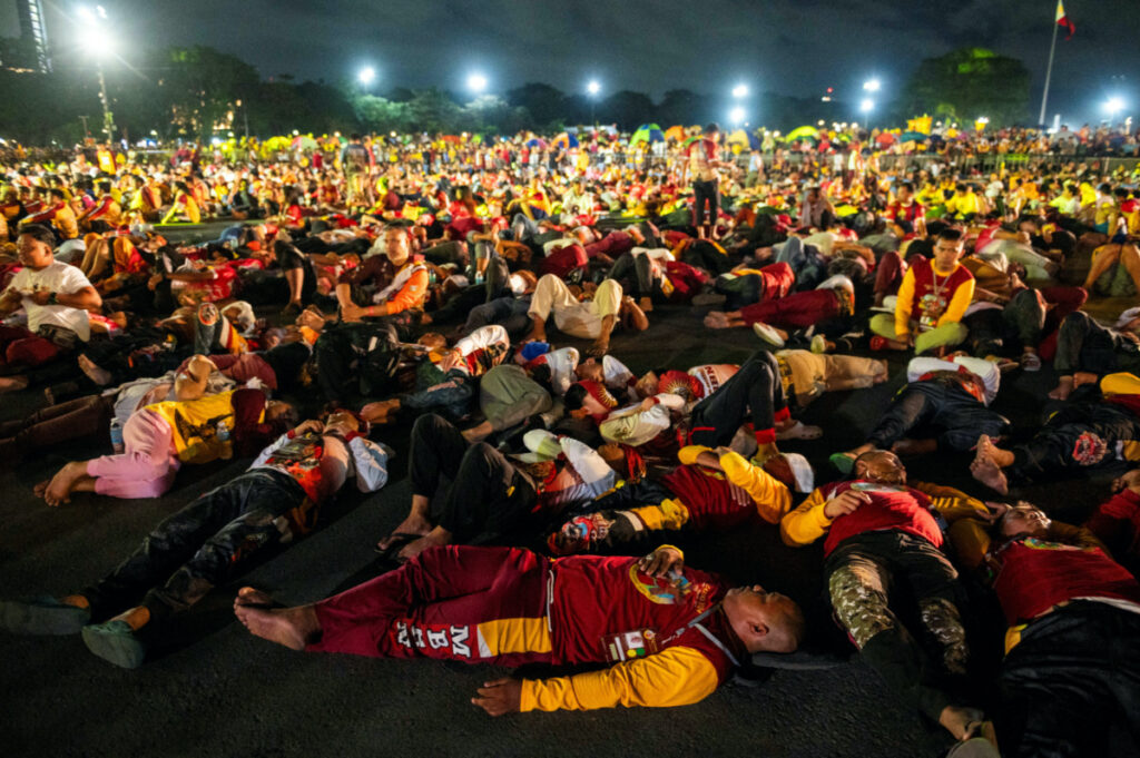 Filipino devotees rest while waiting for the procession of the Black Nazarene to begin, during its feast day and annual procession, in Manila, Philippines, on 9th January, 2024