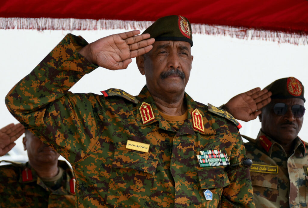 Sudan's General Abdel Fattah al-Burhan salutes as he listens to the national anthem after landing in the military airport of Port Sudan on his first trip away following the crisis in Sudan's capital Khartoum since an internal conflict broke out, in the city of Port Sudan, Sudan, on 27th August, 2023.