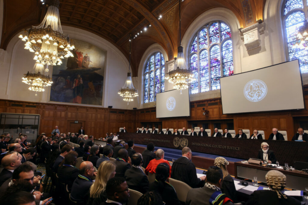 People sit inside the International Court of Justice on the day of the trial to hear a request for emergency measures by South Africa, who asked the court to order Israel to stop its military actions in Gaza and to desist from what South Africa says are genocidal acts committed against Palestinians during the war with Hamas in Gaza, in The Hague, Netherlands, on 11th January, 2024