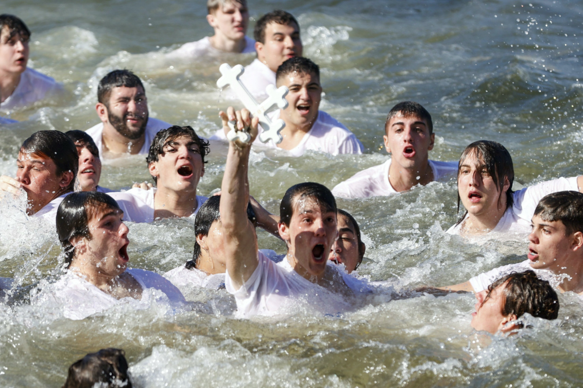 John Hittos, 16, retrieves the cross during the annual cross dive in the Spring Bayou, part of the Epiphany celebration on Saturday, 6th January, 2024, in Tarpon Springs, Florida