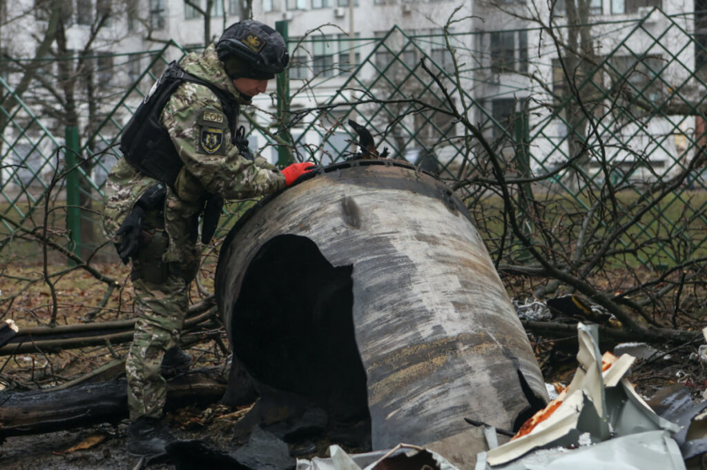 A bomb squad member works next to remains of an unidentified missile at the site where residential buildings were heavily damaged during a Russian missile attack, amid Russia's attack on Ukraine, in central Kharkiv, Ukraine, on 2nd January, 2024.