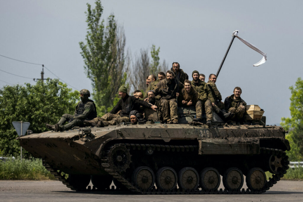 Ukrainian prisoners of war ride atop of an infantry fighting vehicle after a swap, amid Russia's attack on Ukraine, in Donetsk region, Ukraine on 25th May, 2023.