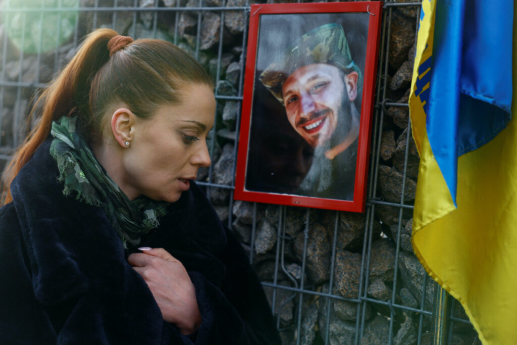 Ukrainian actor Anna Birzul reacts as she visits a grave of her younger brother Bohdan Krotov, a Ukrainian combat medic who was killed in a fight against Russian troops near Bakhmut town, at a cemetery in Kyiv, Ukraine on 28th December, 2023